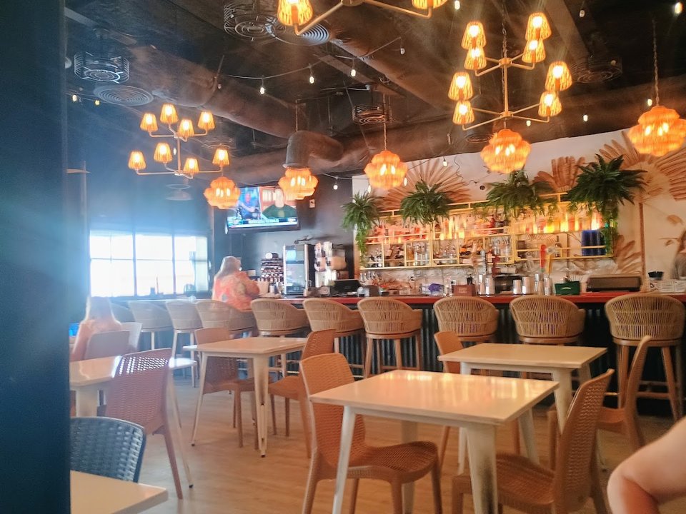 Bar seating inside a laid-back American restaurant.